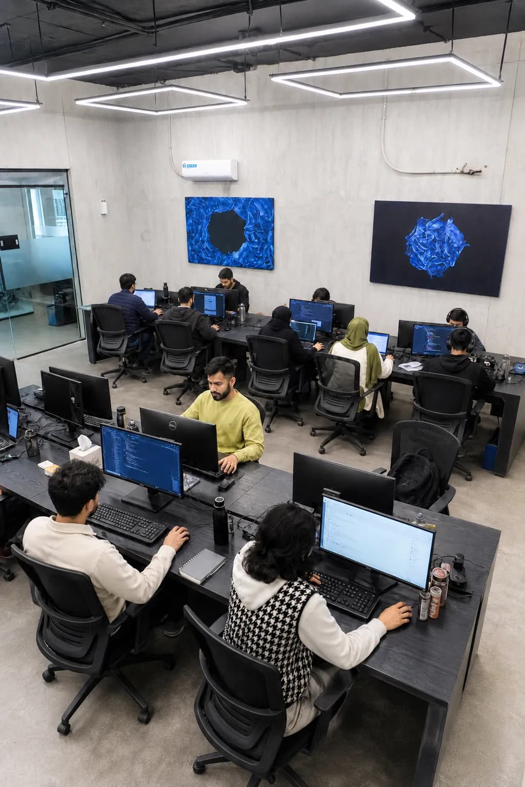 A team at work in a fitted-out RSpace office with rows of desks and screens